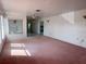 Bright living room with pink carpet and view into kitchen at 10 Golfview S Rd, Rotonda West, FL 33947