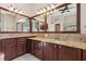 Double vanity bathroom with granite countertops and dark wood cabinets at 10325 Millport Dr, Tampa, FL 33626