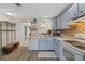 Cozy kitchen with light blue cabinets, stainless steel appliances, and vinyl flooring at 106 Edgewood Ct, Oldsmar, FL 34677