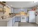 Bright kitchen featuring light blue cabinets, updated countertops, and modern appliances at 106 Edgewood Ct, Oldsmar, FL 34677