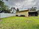 Large backyard with grassy area and white fence at 10908 W Elbow Dr, Tampa, FL 33612