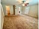 Spacious bedroom with ceiling fan and carpet flooring at 10908 W Elbow Dr, Tampa, FL 33612