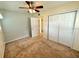 Bedroom with ceiling fan and double door closet at 10908 W Elbow Dr, Tampa, FL 33612