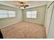 Spacious bedroom with neutral walls, ceiling fan and large windows at 10908 W Elbow Dr, Tampa, FL 33612