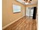 Light and airy bedroom featuring wood-look tile flooring and access to a patio at 10908 W Elbow Dr, Tampa, FL 33612