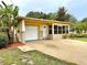 Front view of a single story home with a white garage door at 10908 W Elbow Dr, Tampa, FL 33612