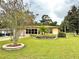 House exterior with landscaping and circular driveway at 10908 W Elbow Dr, Tampa, FL 33612