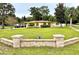 Front view of house with stone wall and landscaping at 10908 W Elbow Dr, Tampa, FL 33612