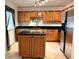 Updated kitchen with wood cabinets and granite countertops at 10908 W Elbow Dr, Tampa, FL 33612