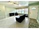 Living room with tile floors, couches and large windows at 10908 W Elbow Dr, Tampa, FL 33612