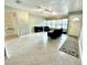 Spacious living area with tile floors and view to kitchen at 10908 W Elbow Dr, Tampa, FL 33612