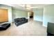 Living room with dark leather couch and tile floors at 10908 W Elbow Dr, Tampa, FL 33612