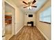 Home office with wood-look tile flooring, ceiling fan and kitchen view at 10908 W Elbow Dr, Tampa, FL 33612
