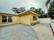 Side patio area with view of the backyard and surrounding landscape at 10908 W Elbow Dr, Tampa, FL 33612