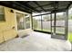 Covered screened patio with concrete flooring and access to backyard at 10908 W Elbow Dr, Tampa, FL 33612
