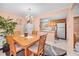 Bright dining area with wood table and chairs, adjacent to kitchen at 1122 84Th N Ter # C, St Petersburg, FL 33702