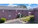 Brick building exterior with walkway, landscaping, and parking at 1122 84Th N Ter # C, St Petersburg, FL 33702