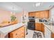 Well-equipped kitchen featuring wood cabinets and modern appliances at 1122 84Th N Ter # C, St Petersburg, FL 33702
