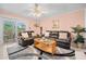Living room with leather sofas and sliding glass doors leading to a balcony at 1122 84Th N Ter # C, St Petersburg, FL 33702