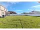 Spacious backyard with grassy area and white fence at 13167 Royal Pines Ave, Riverview, FL 33579