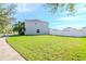 Large backyard with grassy lawn and a white vinyl fence at 13167 Royal Pines Ave, Riverview, FL 33579