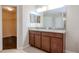 Double vanity bathroom with granite countertop and a walk-in closet at 13167 Royal Pines Ave, Riverview, FL 33579