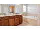 Bathroom boasts double sinks, granite countertop, and a large garden tub at 13167 Royal Pines Ave, Riverview, FL 33579