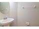 Small bathroom with pedestal sink and oval mirror at 13167 Royal Pines Ave, Riverview, FL 33579