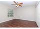Bedroom with ceiling fan, window, and dark brown laminate flooring at 13167 Royal Pines Ave, Riverview, FL 33579
