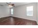 Bedroom with hardwood floors, ceiling fan and two windows at 13167 Royal Pines Ave, Riverview, FL 33579