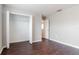 Spacious bedroom with double door closet and dark brown laminate floors at 13167 Royal Pines Ave, Riverview, FL 33579