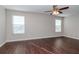 Spacious bedroom with dark hardwood floors and ceiling fan at 13167 Royal Pines Ave, Riverview, FL 33579