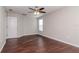 Bright bedroom with ceiling fan, window, and dark brown laminate flooring at 13167 Royal Pines Ave, Riverview, FL 33579