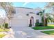 Two-story house with red door, attached garage, and landscaped lawn at 13167 Royal Pines Ave, Riverview, FL 33579