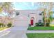 Two-story house with red door, attached garage, and landscaped lawn at 13167 Royal Pines Ave, Riverview, FL 33579