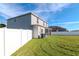 Rear view of house with screened porch and fenced yard at 13167 Royal Pines Ave, Riverview, FL 33579