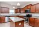 Modern kitchen with granite countertops and island at 13167 Royal Pines Ave, Riverview, FL 33579