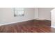 Living room with hardwood floors, large window, and white door at 13167 Royal Pines Ave, Riverview, FL 33579