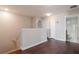 Upper hallway with dark hardwood floors and access to bathroom at 13167 Royal Pines Ave, Riverview, FL 33579
