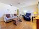 Bright living room featuring hardwood floors, a sofa, and a ceiling fan at 1517 Young Ave, Clearwater, FL 33756