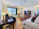 Living room with hardwood floors, comfortable seating and a ceiling fan at 1517 Young Ave, Clearwater, FL 33756
