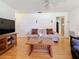 Living room with hardwood floors, comfortable seating, and a large TV at 1517 Young Ave, Clearwater, FL 33756