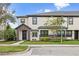 Two-story townhome with brick and white exterior, landscaping, and a front walkway at 16111 Churchview Dr, Lithia, FL 33547