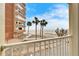 Balcony view of the beach, ocean and palm trees at 17960 Gulf Blvd # 123, Redington Shores, FL 33708