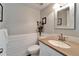 Guest bathroom with granite countertop and wood-look tile at 17960 Gulf Blvd # 123, Redington Shores, FL 33708