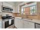 Stainless steel appliances and light wood cabinets in this galley kitchen at 17960 Gulf Blvd # 123, Redington Shores, FL 33708