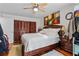 Comfortable bedroom featuring a ceiling fan, hardwood floors, and a spacious closet at 2579 Countryside Blvd # 1105, Clearwater, FL 33761