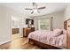 Main bedroom with a king-size bed, dresser, and ensuite bathroom at 3951 Claybrook Dr, Wesley Chapel, FL 33544