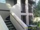 Exterior view of condo building with stairs and screened balcony at 4036 Angel Oak Ct # 101, Tampa, FL 33613