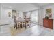 Bright dining room with four chairs, light wood floors, and large window at 415 21St N St, St Petersburg, FL 33713